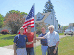 FLAGBEARERS: (Left to right) Mike Krake, Don Gabriele, Rotary President Bryan Higgins and Jim Jickess hold one of the Rotary’s American flags from the Fly the Flag program in June.